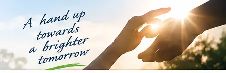 Two hands reaching towards sunlight with the words A hand up towards a brighter tomorrow